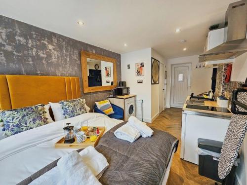 a bedroom with a bed with a tray on it at Cobblestone Studio by Fortuna Property Portfolio in Cheltenham