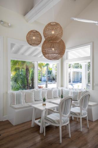 a living room with a couch and a table and chairs at Paradise Inn - Adult Exclusive in Key West