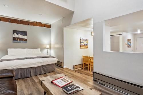 a bedroom with a bed and a living room with a table at THE CARRICK in Bisbee