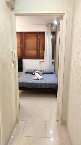 a bedroom with a bed with blue sheets and curtains at Magnifique Studio du Chateau VLP in Vaux-le-Pénil