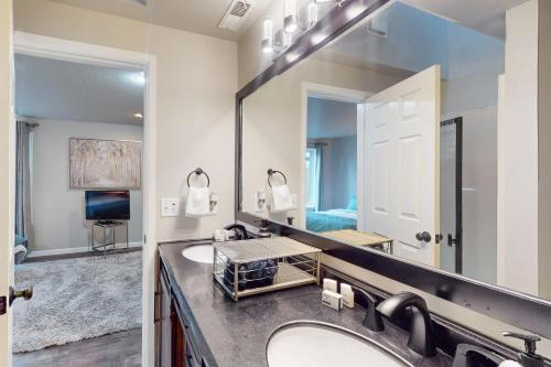 a bathroom with two sinks and a large mirror at The Peaceful Den in Eugene