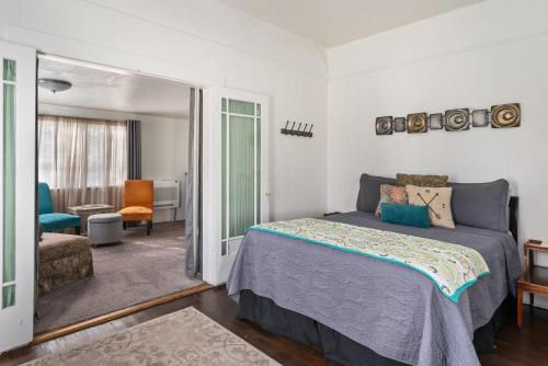 a bedroom with a bed and a living room at Downtown Urban Flat - close to SMART Station in Santa Rosa