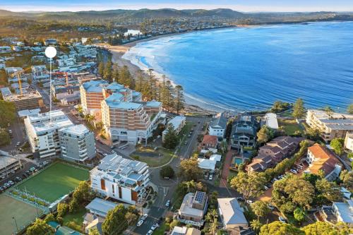 an aerial view of a city and the beach at Modern & Cozy Unit Just Steps from Terrigal Beach in Terrigal