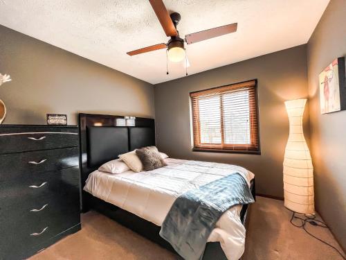 a bedroom with a bed and a ceiling fan at New 3 bd 2 bath Hot tub in Omaha