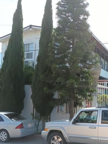 a car parked in front of a building with trees at Apartamentos Rosarito.!! Con Vista al Mar ! in Rosarito