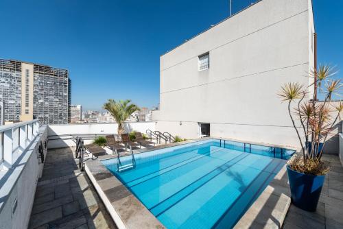 a swimming pool on the roof of a building at Rover Centro in Sao Paulo