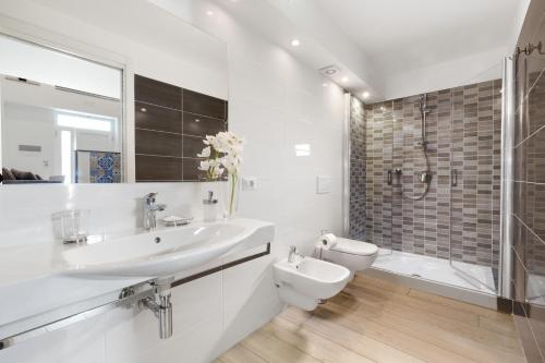 a bathroom with a sink and a toilet and a shower at Eterea Charming Suites in Sorrento