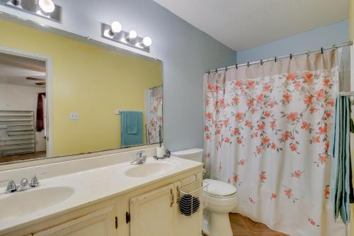 a bathroom with a sink and a toilet and a mirror at McAllen Vacation Rental Less Than 10 Mi to La Plaza Mall! in McAllen
