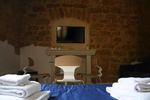 a room with a bed and a fireplace and a tv at Bamboo Luxury B&B in Agrigento