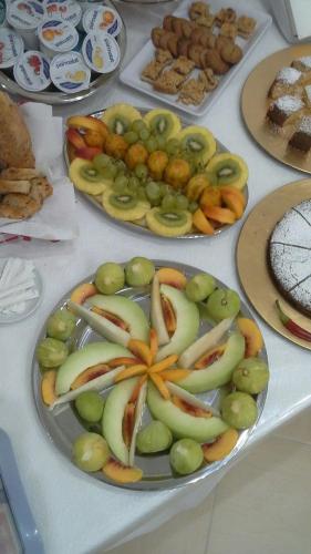 a table topped with plates of apples and other food at Agriturismo Casa del Peperoncino in Otranto