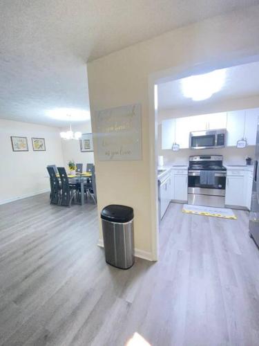 an empty room with a kitchen and a dining room at A Touch of Sunshine Ideal For Long Term Stays in Fayetteville
