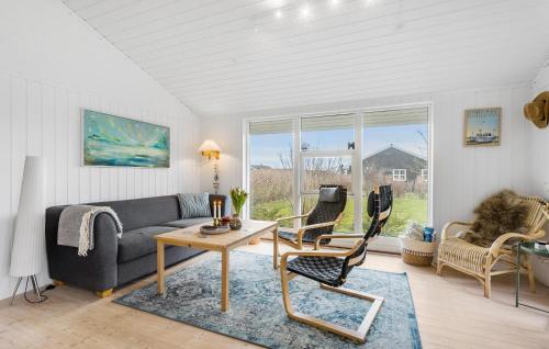 a living room with a couch and a table at 2 Bedroom Lovely Home In Rudkøbing in Spodsbjerg