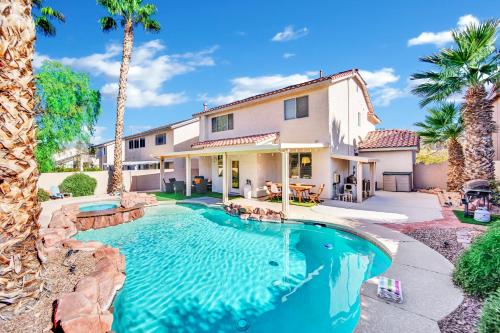 a house with a swimming pool and palm trees at Seven Palms in Henderson