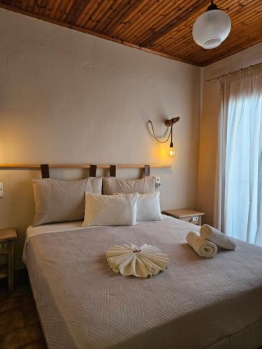a bedroom with a bed with two towels on it at Corali rooms pelion in Agios Ioannis Pelio