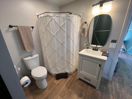 a bathroom with a toilet and a sink and a mirror at Bryce Glamp And Camp in Cannonville