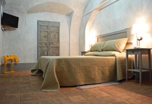 a bedroom with a bed with a table and a door at Il Viaggiatore 2 in Anagni