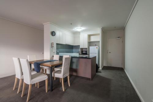 a kitchen and dining room with a table and chairs at IMSA Group in Melbourne