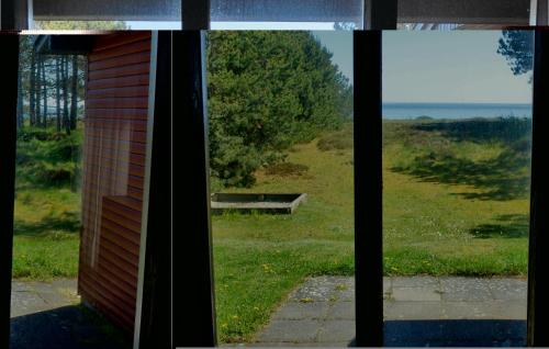 a window looking out at a view of a field at Mugge in Ebeltoft