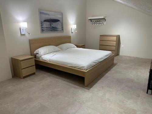 a bedroom with a large bed and two night stands at Departamentos Flamboyant in Acapulco