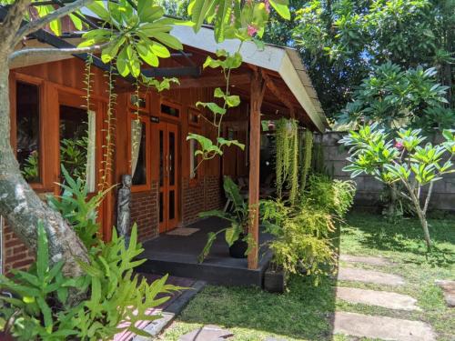 a small house in the middle of a garden at Tahlia's Villa in Sorongjukung