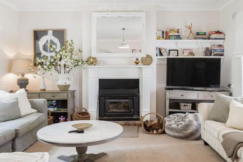 a living room with a table and a fireplace at Serenity in Red Hill - Winery Bliss & Coastal Beauty in Red Hill South