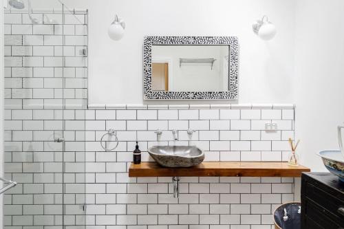 a bathroom with a sink and a mirror at Cottage Enchantment Blooming Garden Getaway in Red Hill South