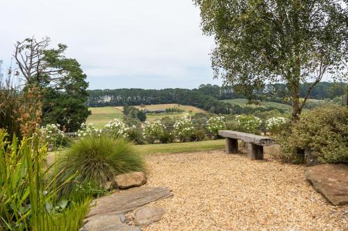 a bench sitting in the middle of a garden at Serenity in Red Hill - Winery Bliss & Coastal Beauty in Red Hill South