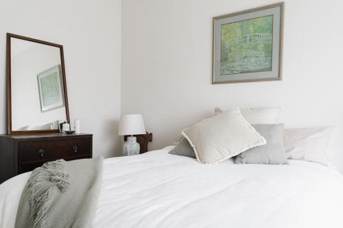 a bedroom with a white bed and a mirror at Serenity in Red Hill - Winery Bliss & Coastal Beauty in Red Hill South