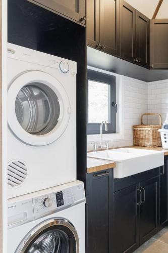 a kitchen with a washing machine and a sink at Serenity in Red Hill - Winery Bliss & Coastal Beauty in Red Hill South