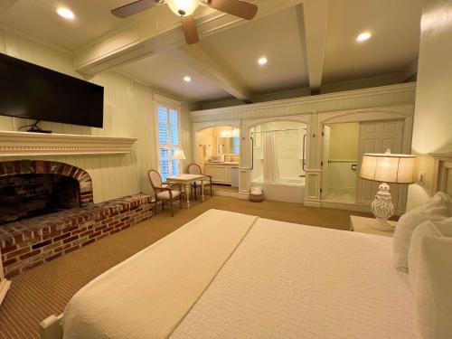 a bedroom with a fireplace and a bed and a tv at Best Western Grandma's Feather Bed in Mendenhaven