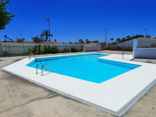 a swimming pool in the middle of a building at Los Porches D40 By Pride Holiday Rentals in San Bartolomé