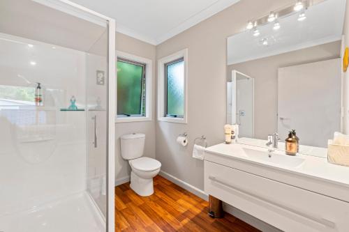 a bathroom with a toilet and a sink and a shower at Bach 32 - Taupo Holiday Home in Taupo