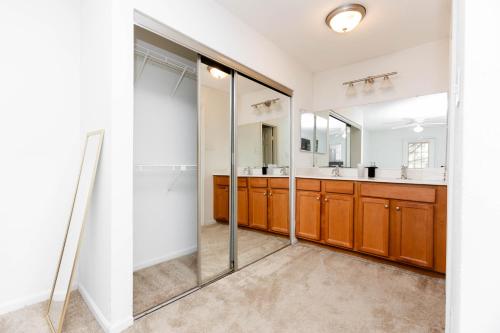 a bathroom with a glass shower and a sink at Wyndham 219 Modern 2br Suite, Parking in Hampton