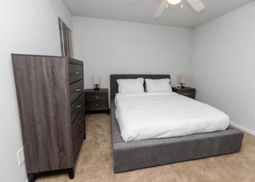 a bedroom with a bed and a dresser at Modern Luxe 2bd2ba I Free Parking I Wyndham in Hampton