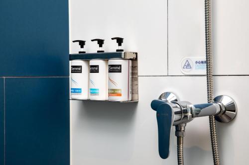 a bathroom with a soap dispenser on the wall at Holiday Inn Express Hong Kong Causeway Bay by IHG in Hong Kong