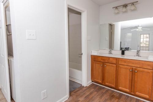 a bathroom with a sink and a mirror at Modern Luxe 2bd2ba I Free Parking I Wyndham in Hampton