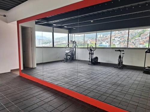 a gym with cardio equipment in a room with windows at Apartamento Manizales II in Manizales