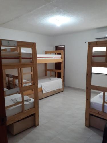 a room with several bunk beds in a room at casa vacacional cabañas altamar san andres islas in San Andrés
