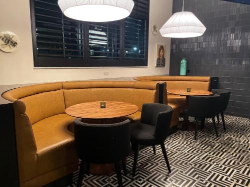 a waiting room with two tables and chairs and a couch at The Haywood, Tapestry Collection by Hilton in El Dorado