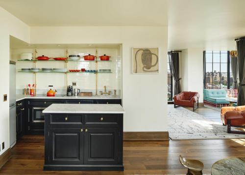a kitchen with a black island in a room at The Ludlow Hotel in New York