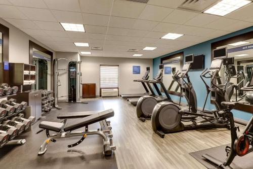 a gym with treadmills and elliptical machines at Hampton Inn & Suites Indianapolis-Airport in Indianapolis