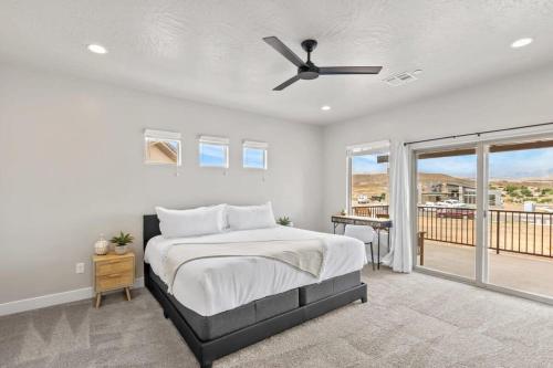 a bedroom with a bed and a ceiling fan at Zion Village Private Poolside Home in Hurricane