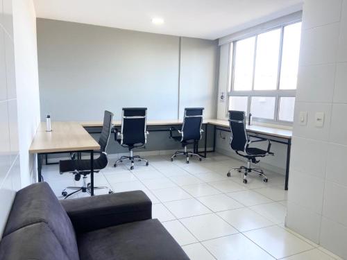 a room with a couch and a table and chairs at Flat WiseSP - Expo Anhembi in Sao Paulo