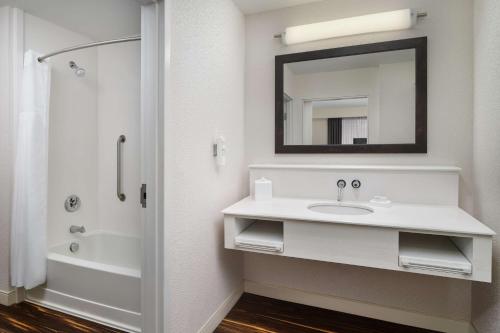 a white bathroom with a sink and a mirror at Hampton Inn & Suites - Richmond - Downtown, VA in Richmond
