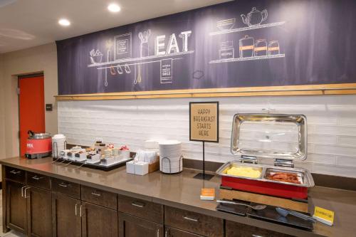 a fast food restaurant with a counter with food at Hampton Inn & Suites - Cincinnati/Kenwood, OH in Cincinnati
