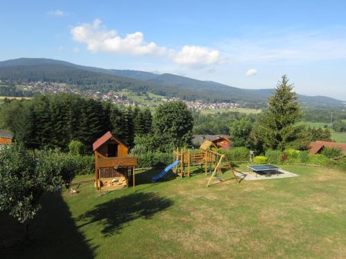 a backyard with a playground with a play set at Gästehaus Weber in Arrach