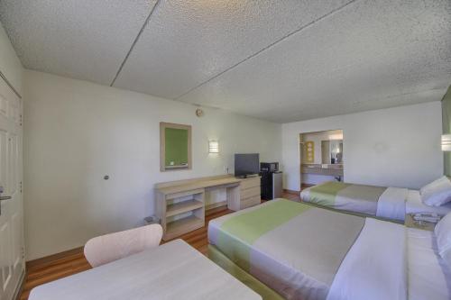 a hotel room with two beds and a desk at Motel 6-San Antonio, TX - Northwest Medical Center in San Antonio