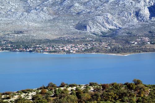 an aerial view of a lake in front of a mountain at Apartments with parking space Seline, Paklenica - 22077 in Starigrad-Paklenica
