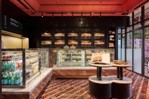 a bakery with two stools in front of a counter at Conrad Singapore Orchard in Singapore