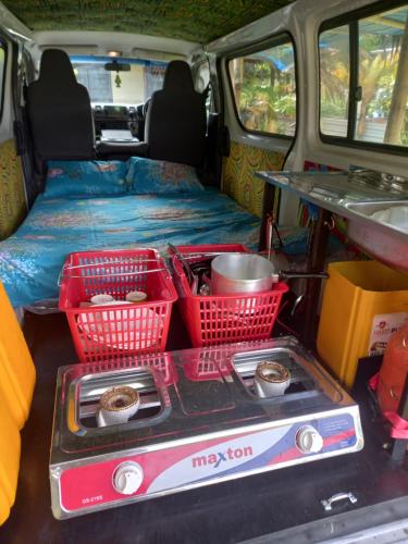 a van with baskets of food in the back of it at Turtle Campervans Fiji in Korotogo